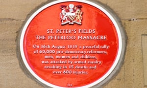Red plaque commemorating the Peterloo massacre in Manchester.