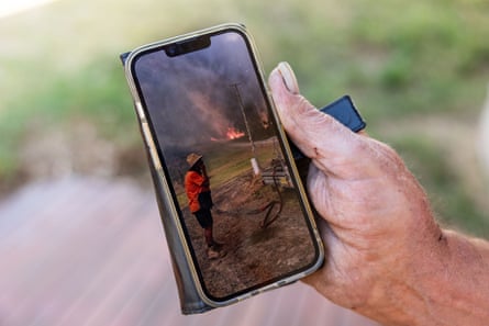 Garry Morgan with photograph of him during the fire.