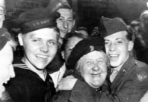 US soldiers hug an English woman as they celebrate the surrender of Germany, May 7, 1945, in London’s Piccadilly Circus