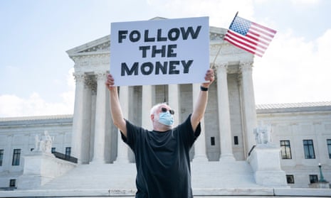 A man protests outside the supreme court in Washington during a case about releasing Donald Trump’s tax returns this summer.