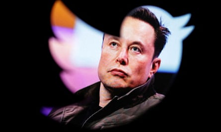 Elon Musk seen through a Twitter logo window.