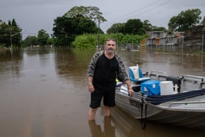 Australia news live update: Sydney floods wreak havoc; Manly dam begins to spill as NSW flood waters rise; man shot by NT police 1 Anthony Lippis drives his dinghy up and down the flooded road to check in on his neighbours
