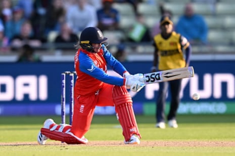 Danni Wyatt-Hodge of England hits the ball to the boundary for four runs to reach her century.