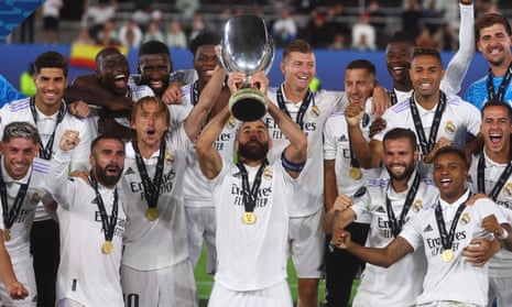 Real Madrid's Karim Benzema lifts the trophy as he celebrates with teammates after winning the European Super Cup.