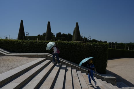 Visitors walk in the garden of the Palace of Versailles