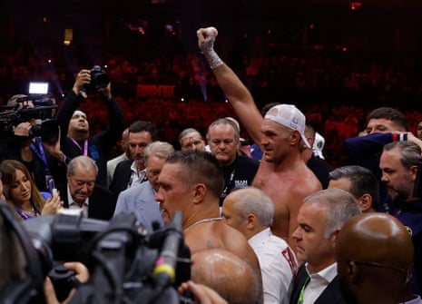 Fury raises his arm after his split-decision defeat to Usyk early Sunday morning in Riyadh.