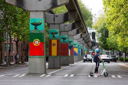 Flags of participating countries are displayed on the Seattle monorail