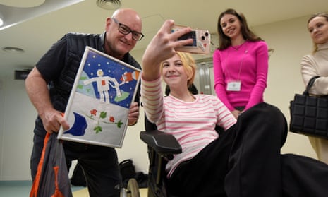 Retired Nasa astronaut Scott Kelly with Kateryna Iorhu, 13, who was injured and lost her mother in a Russian missile strike on a railway station in Kramatorsk