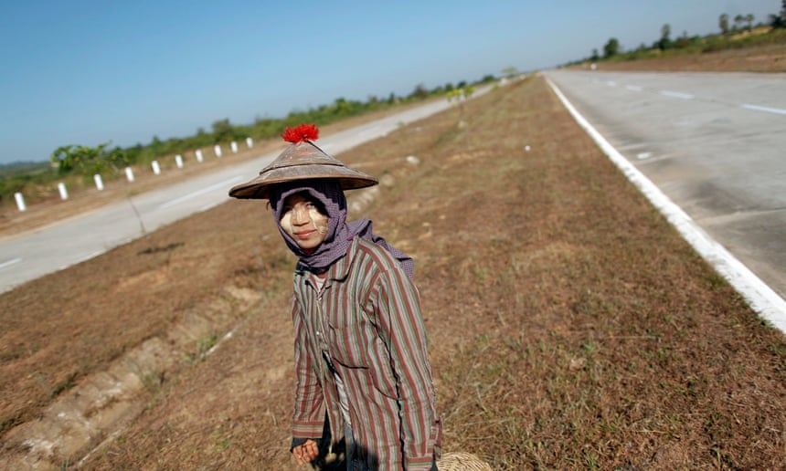 A girl walks between lanes of an empty highway connecting Myanmar’s biggest city Yangon and its new capital Naypyitaw.