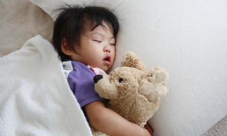 Little girl sleeping with teddy.