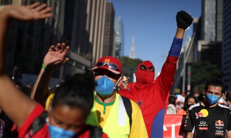 A man dressed as Spiderman shouts and raises his wrist during a protest to demand the impeachment of Brazil’s president Jair Bolsonaro and against his handling of the coronavirus pandemic, on Paulista Avenue in Sao Paulo, Brazil.