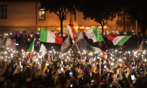 Demonstrators wave flags and shine phone torches at an anti-green pass protests in Rome on Saturday.