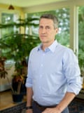 A solemn middle-aged white man looks at the camera