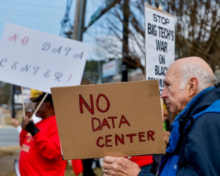 A protest with people holding signs saying ‘no data center’