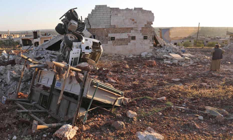 A man gazes at rubble and damaged vehicles following reported airstrikes by the Syrian regime ally Russia, in the town of Kafranbel in the rebel-held part of the Syrian Idlib province on May 20, 2019