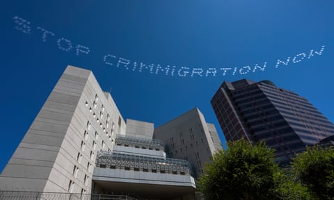 ‘STOP CRIMMIGRATION NOW’ is seen over the Metropolitan Detention Center in Los Angeles, California.