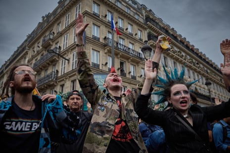 Protesters chant as they demonstrate outside Gare du Nord railway station against French president Emmanuel Macron and his government.