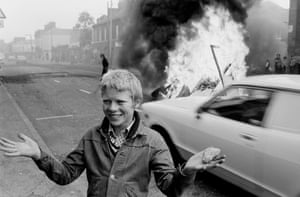 Youth with a stone during a riot at the top of Leeson Street, west Belfast, 1978