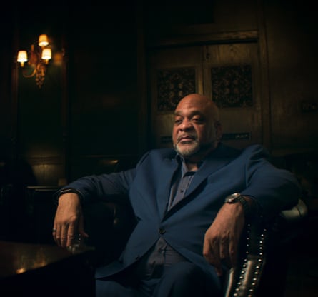 Former superintendent Eddie Johnson sits in an armchair under a light in a dark room in The Truth About Jussie Smollett