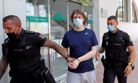 British citizen Joseph James O'Connor is lead by Spanish police officers as he leaves a court in 2020.