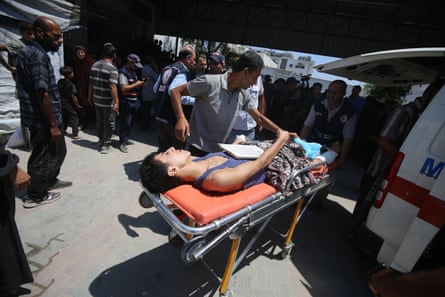 An injured man is brought to al-Shifa hospital in Gaza City after Israeli forces opened fire on civilians who were waiting for humanitarian aid near Gaza City on Sunday.