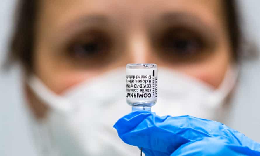 A doctor prepares a vial of the Pfizer/BioNTech Comirnaty vaccine against Covid-19 at a vaccination center in Germany.