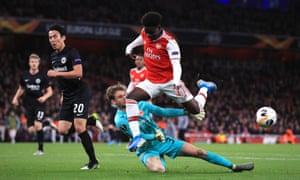 Arsenal’s Bukayo Saka (right) is thwarted by Eintracht Frankfurt goalkeeper Frederik Rönnow.