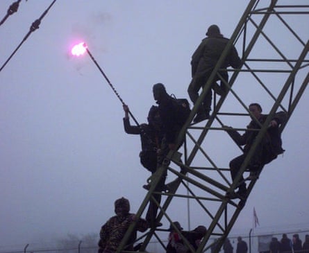 1996: Newbury bypass protesters climb on to a crane in the secure area, despite police efforts to stop them.