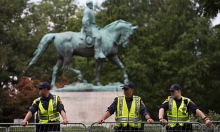 A heavy police presence in front of the statue of civil war Confederate General Robert E Lee.