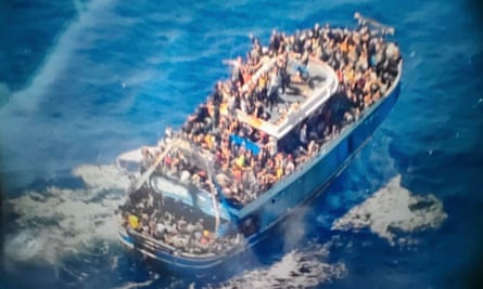 Overcrowded boat in blue sea