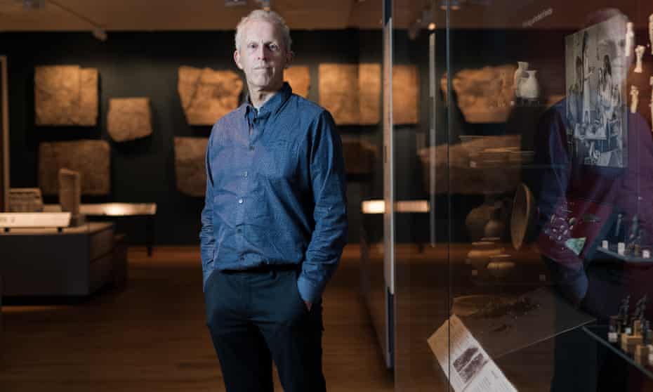 Prof Chris Gosden of Oxford University with artefacts in the background