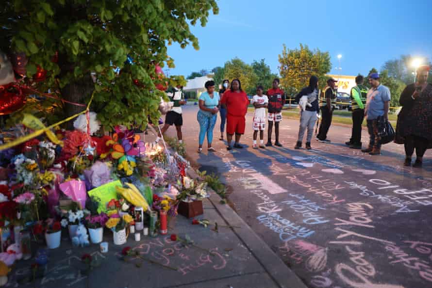 Names of victims and messages of healing are chalked on the ground at a makeshift memorial outside of Tops market in Buffalo, New York.