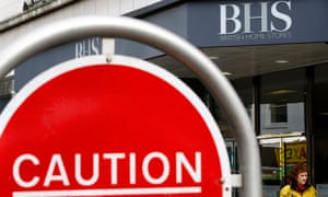 A woman walks past a BHS store in Leicester.