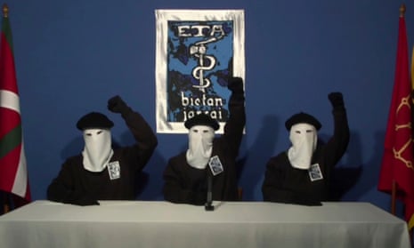 Masked members of the Basque separatist group Eta raise their fists in a familiar pose during a news conference in 2011