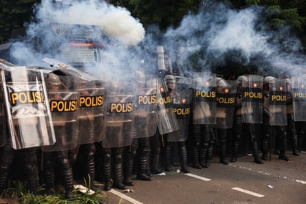 Riot police react as they clash with demonstrators during a protest outside the Indonesian parliament in Jakarta, Indonesia, 25 August 2025.