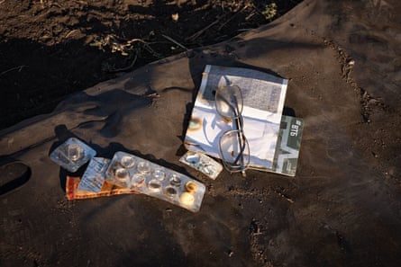 Belongings recovered from a dead Russian soldier, including medication blister packs and broken spectacles.