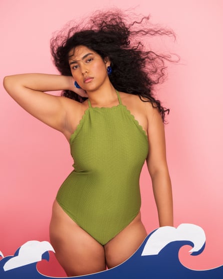 Model wearing a green scalloped swimsuit