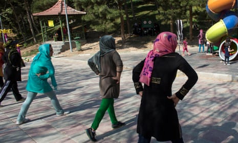 Women exercise in a park in Tehran