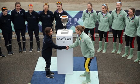 Eleanor Shearer, president of Oxford University Women’s Boat Club shakes hands with Abigail Parker, president of Cambridge University Women’s Boat Club.