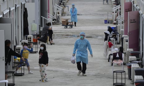 Healthcare workers deliver supplies to patients at a makeshift isolation facility in the San Tin area of Hong Kong