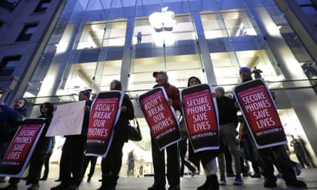 Protesters carry placards outside an Apple store in Boston in February.
