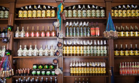 Bottles of mezcal and other spirits on sale in a shop.