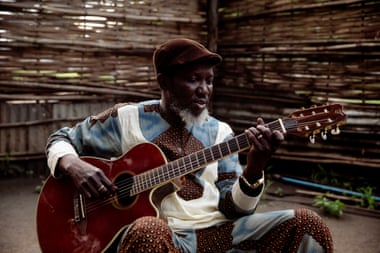 Emmanuel Kembe playing guitar