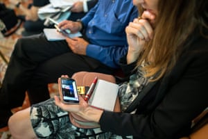 A journalist watches David Cameron’s speech in response to the result of the UK’s EU referendum on her smartphone before a press statement by the Austrian chancellor, Christian Kern