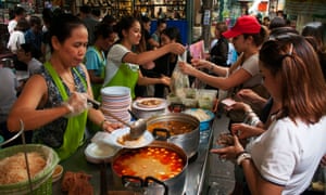 ‘It brings all the classes together’: office workers buy khanom chin, spicy curry and fresh noodles.