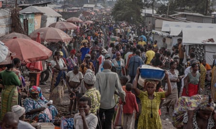 Thousands of people walking through a busy street, just outside Goma.