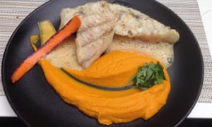 John Dory with carrot mousseline on a black round plate