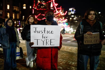 people hold signs that read ‘justice for Tyre’ and ‘no more killer cops’