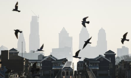Birds fly over trains along the Market-Frankford Line in Philadelphia.