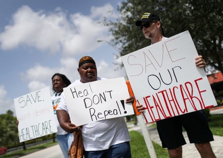 people hold signs in support of healthcare